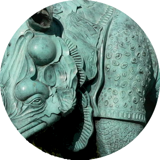 circular detail (eye, cheek and shoulder) of rhinoceros sculpture in metal
